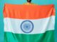 a man holding the flag of india